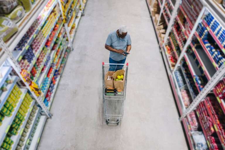 man shops at grocery store